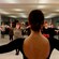 An instructor in a dance studio facing her students